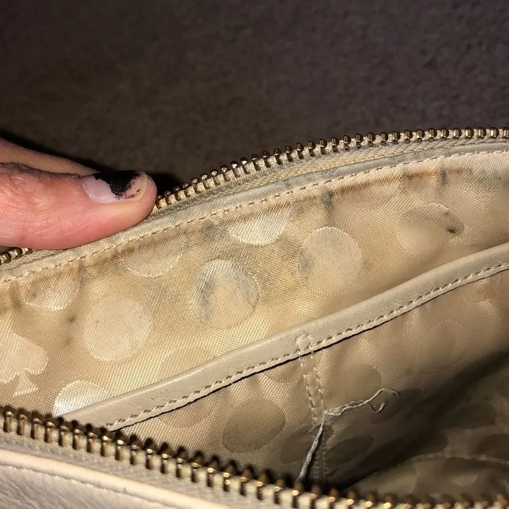 Kate Spade cream purse with a black bow